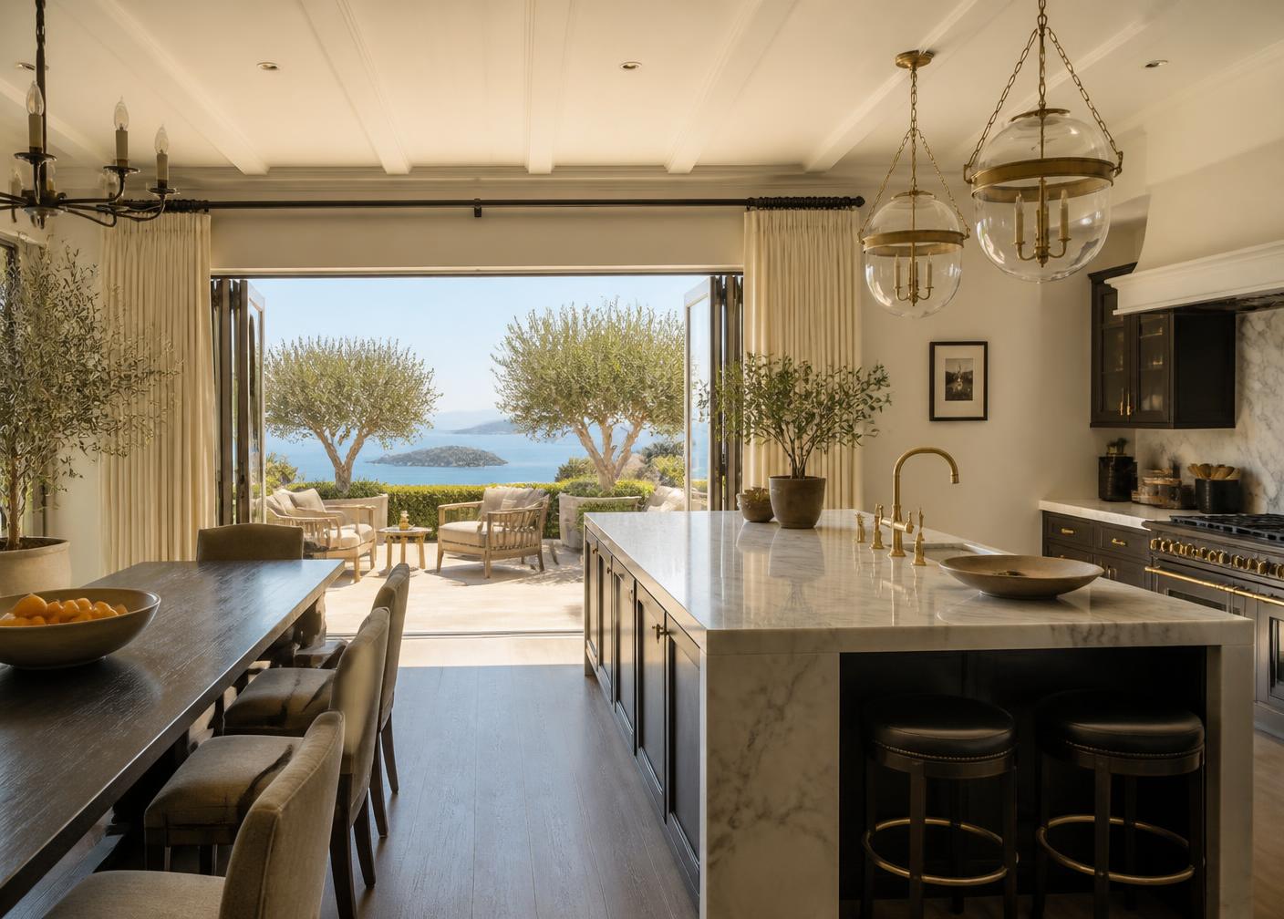 Villa kitchen opening onto an olive terrace with sea views